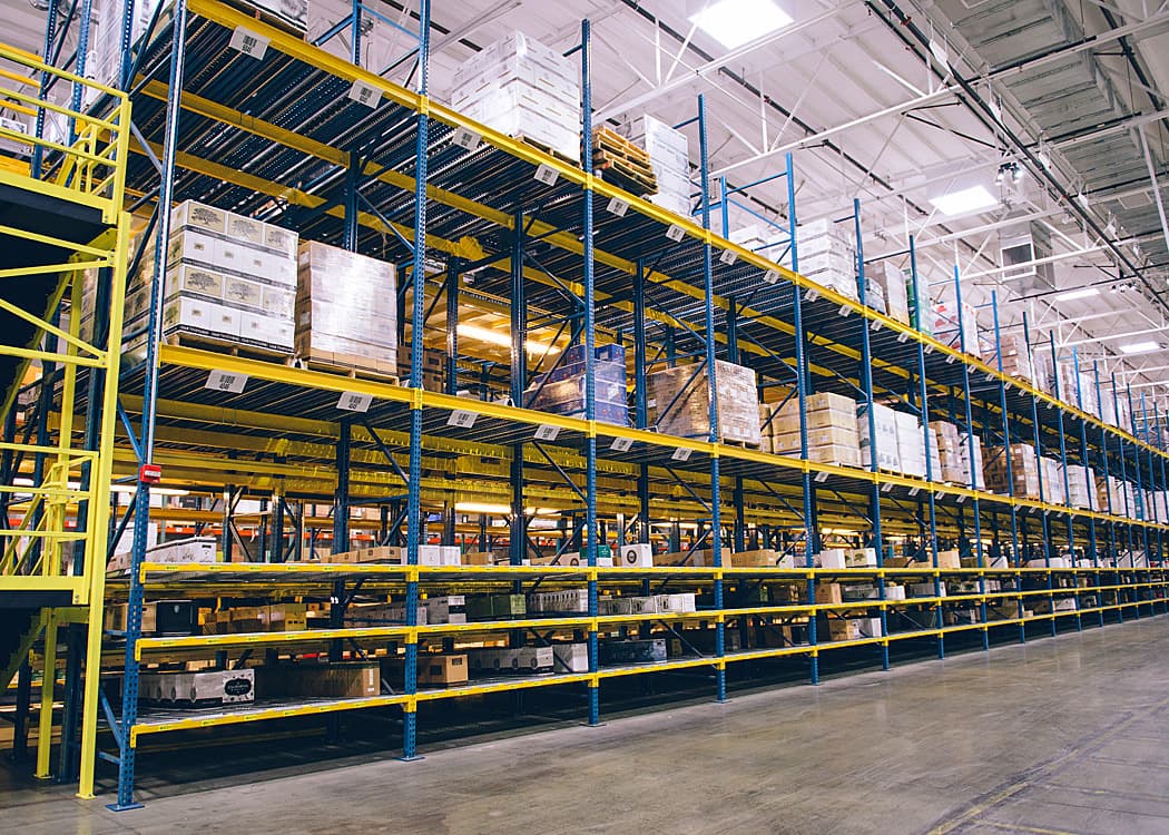 High-density storage racking system in a warehouse facility